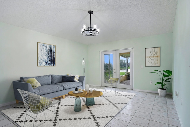 tiled living room with french doors, a textured ceiling, and a notable chandelier