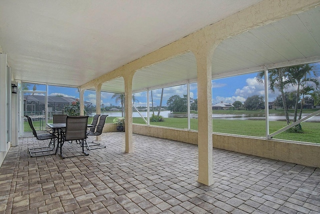 sunroom / solarium featuring a water view