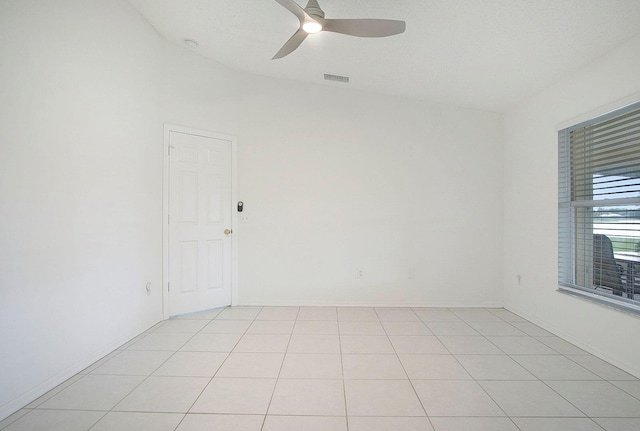 spare room with ceiling fan and light tile patterned floors