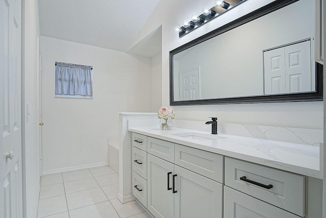 bathroom featuring a washtub, vanity, and tile patterned floors