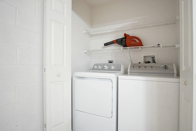 washroom with washing machine and clothes dryer