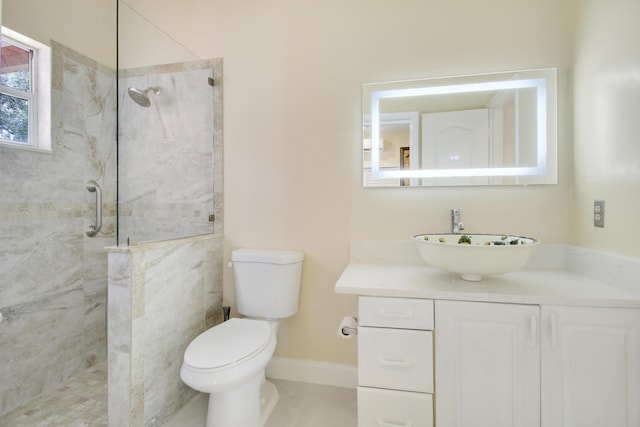 bathroom featuring tile patterned floors, a shower with door, vanity, and toilet