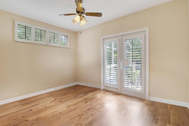 unfurnished room with light wood finished floors, a healthy amount of sunlight, a ceiling fan, and baseboards