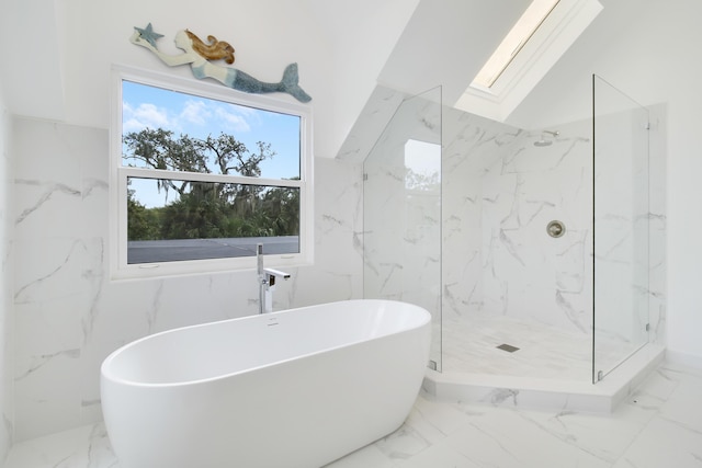 full bathroom with a marble finish shower, marble finish floor, a freestanding bath, and a skylight