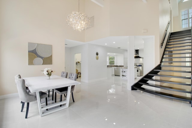 dining area featuring a high ceiling and a notable chandelier