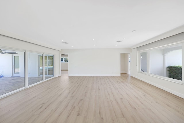 unfurnished living room featuring ceiling fan and light hardwood / wood-style floors