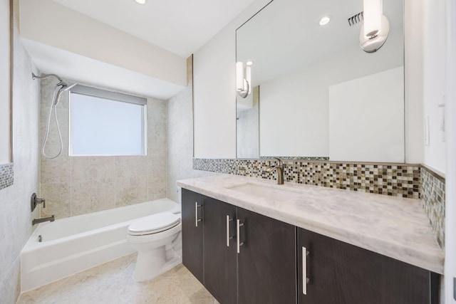 full bathroom with backsplash, vanity, tiled shower / bath combo, tile walls, and toilet