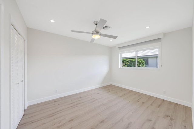 unfurnished bedroom featuring ceiling fan, a closet, and light hardwood / wood-style flooring