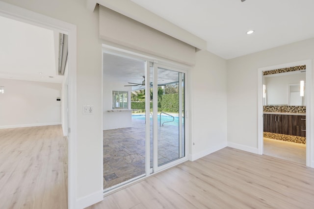 spare room with ceiling fan and light wood-type flooring