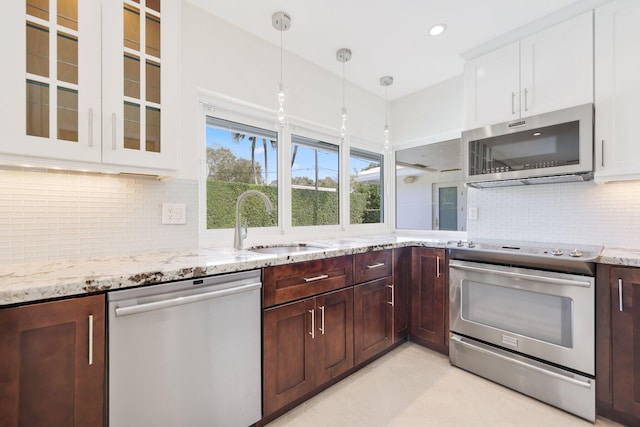 kitchen with white cabinetry, sink, decorative light fixtures, dark brown cabinets, and appliances with stainless steel finishes