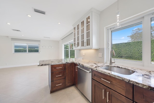 kitchen featuring white cabinets, dishwasher, sink, and tasteful backsplash