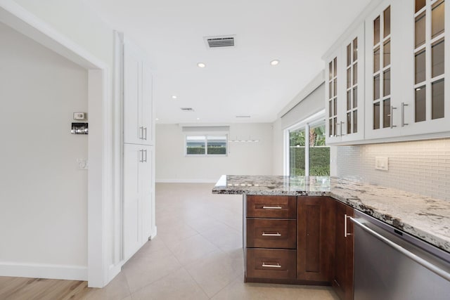 kitchen with backsplash, stainless steel dishwasher, light stone counters, dark brown cabinetry, and white cabinetry