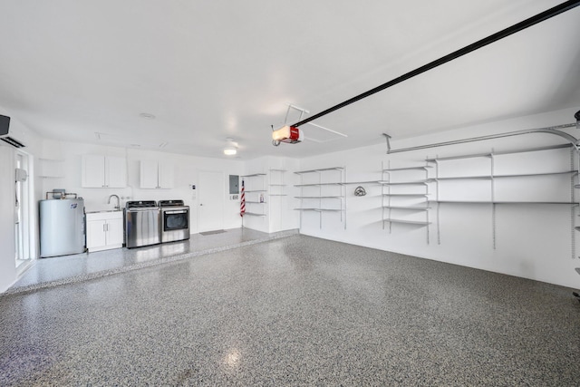 garage with washing machine and clothes dryer, electric panel, water heater, and a garage door opener