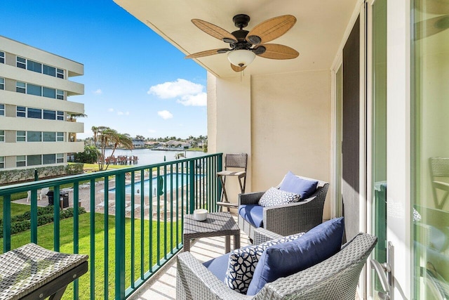 balcony with a water view and ceiling fan