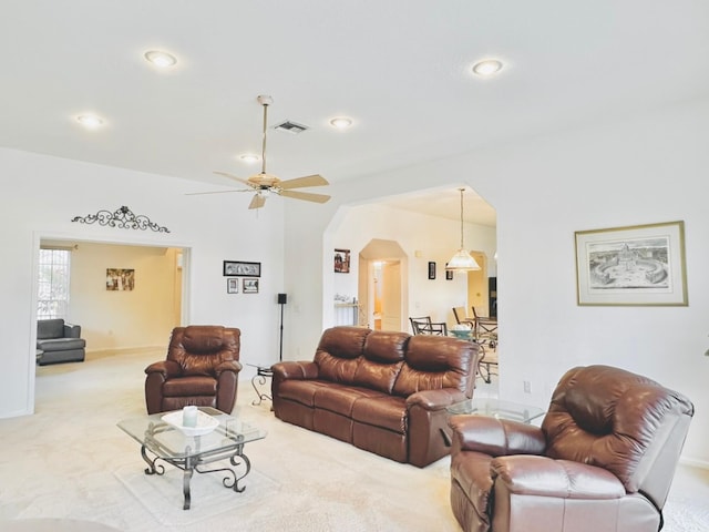 carpeted living room featuring ceiling fan