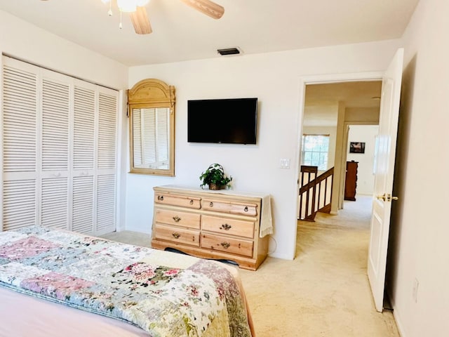 bedroom with light carpet, a closet, and ceiling fan