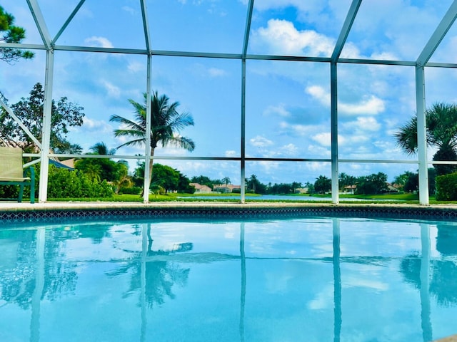 view of swimming pool featuring a lanai