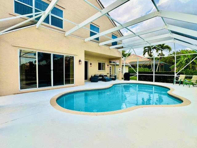 view of swimming pool with an outdoor living space, a patio area, and a lanai