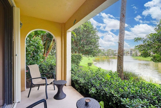 view of patio with a water view