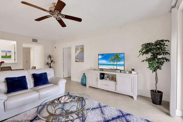 tiled living room with ceiling fan