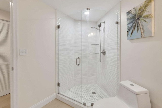 bathroom with toilet and an enclosed shower