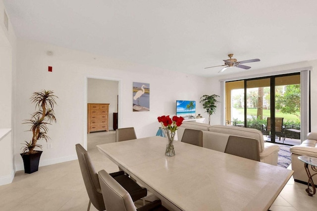 tiled dining space featuring ceiling fan