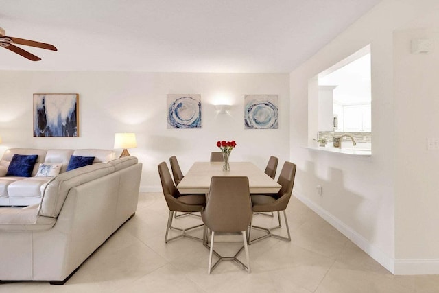 tiled dining area featuring ceiling fan