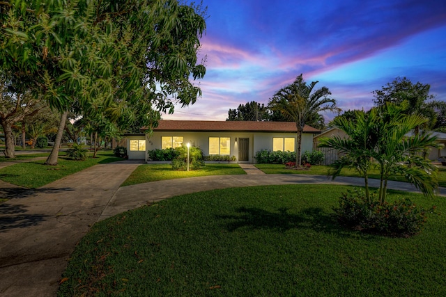 ranch-style home featuring a yard