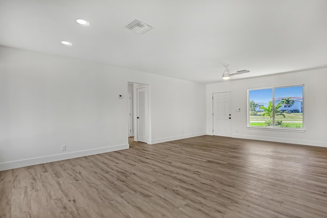 unfurnished living room featuring ceiling fan and light wood-type flooring