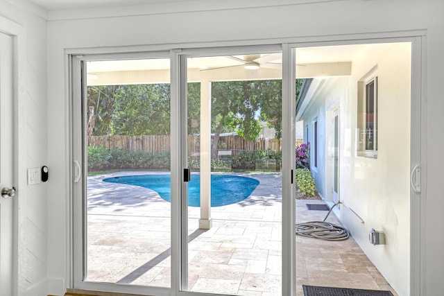 doorway to outside with ceiling fan