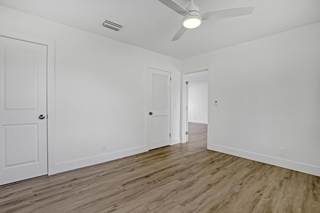 spare room featuring ceiling fan and light hardwood / wood-style floors