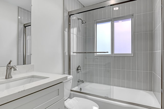 full bathroom with vanity, toilet, and enclosed tub / shower combo