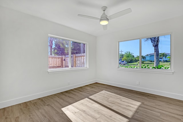 empty room with ceiling fan and hardwood / wood-style floors