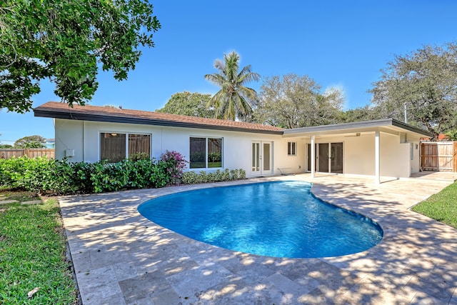 view of pool featuring a patio area and french doors