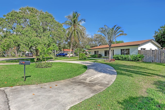 ranch-style home with a front lawn