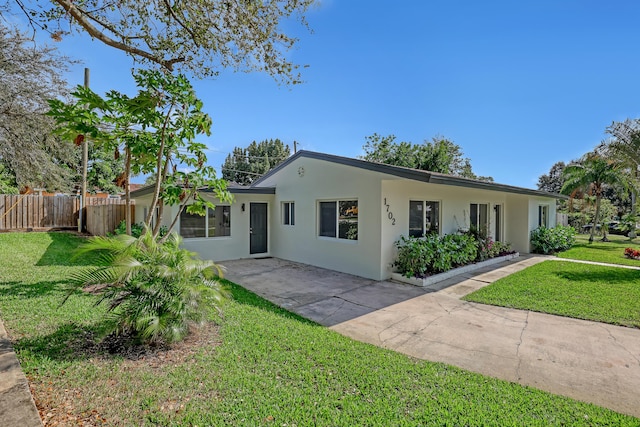 ranch-style home with a front yard