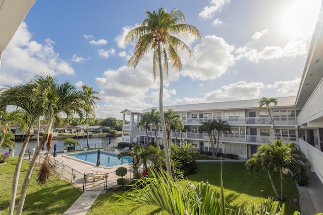 1152 NW 30th Ct Unit 212, Wilton Manors, FL 33311 - view of pool featuring fence, a fenced in pool, a water view, and a patio area