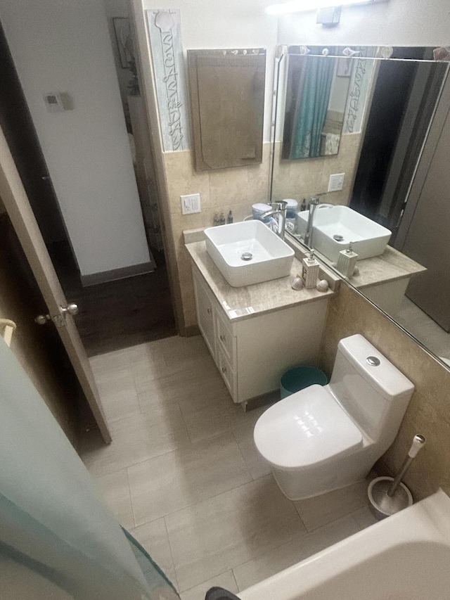 bathroom featuring tile patterned flooring, vanity, and toilet