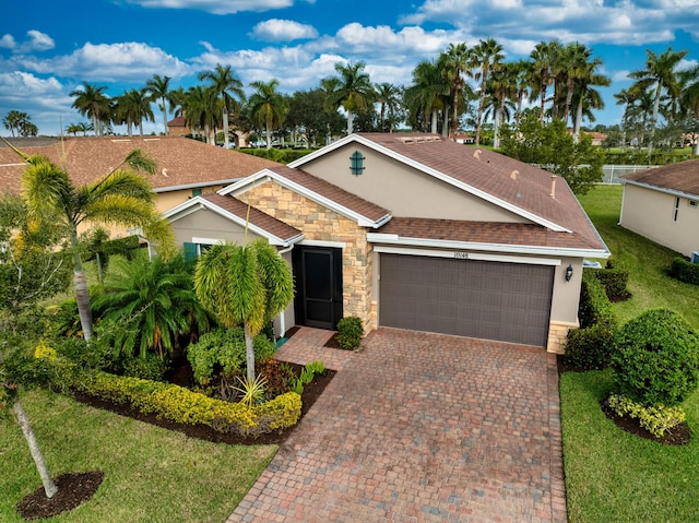 ranch-style home with a front lawn and a garage