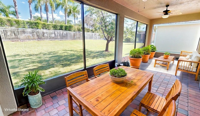 sunroom featuring plenty of natural light and ceiling fan