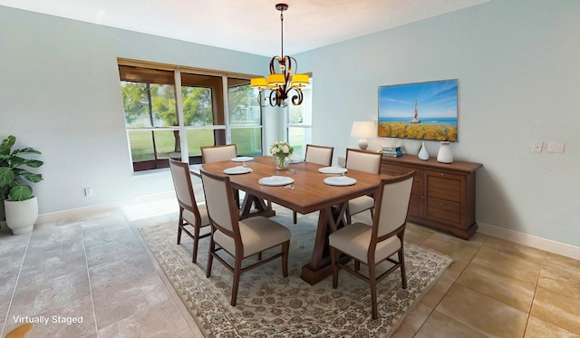 tiled dining room featuring an inviting chandelier