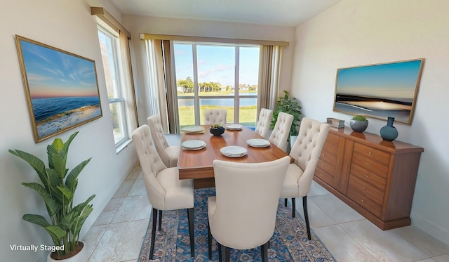 tiled dining area featuring a wealth of natural light and a water view