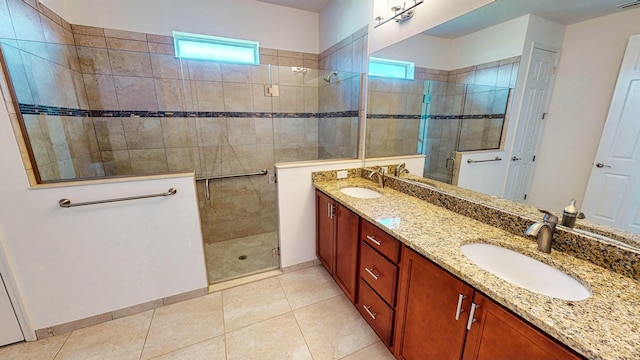 bathroom with tile patterned floors, vanity, and a shower with shower door