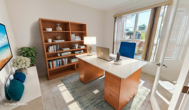 office with light tile patterned floors and french doors