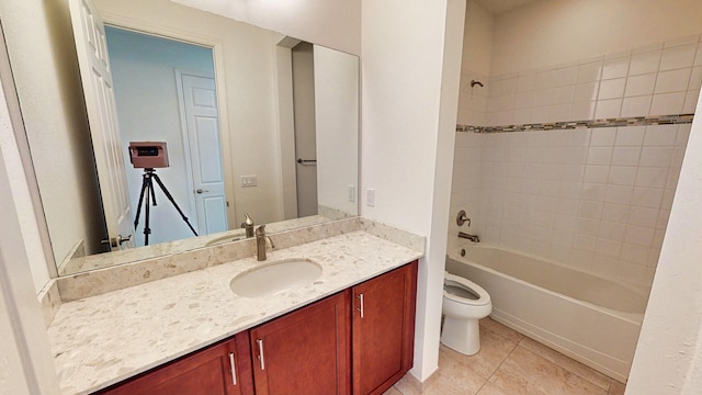 full bathroom with toilet, vanity, tiled shower / bath combo, and tile patterned flooring