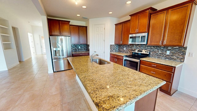 kitchen featuring a center island with sink, sink, and appliances with stainless steel finishes