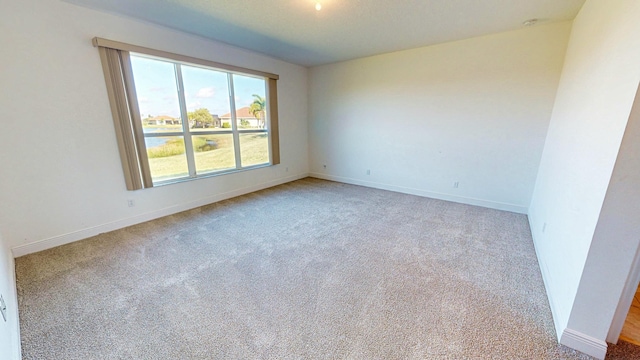 unfurnished room featuring carpet