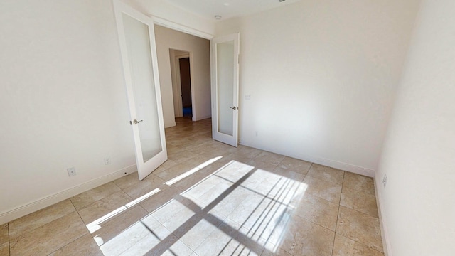 unfurnished room featuring french doors