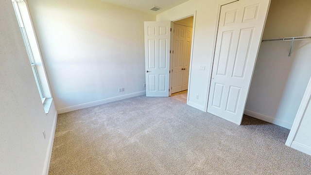 unfurnished bedroom featuring light colored carpet