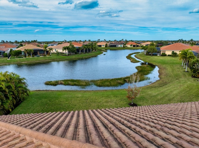 view of community with a water view and a yard